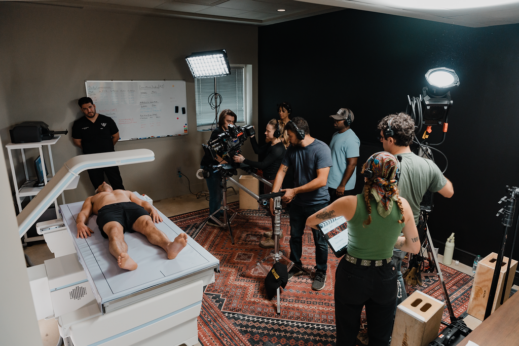 Full production crew with cinema camera, gaffer, and lighting rigs on a Social Cuts set