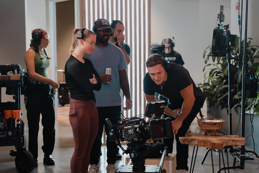 Crew huddled around a cinema camera reviewing a shot on a Social Cuts production